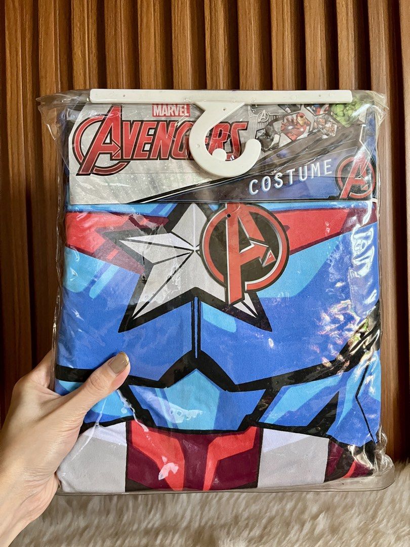 Marvel Avengers Captain America Costume (Category: Babies & Kids Fashion) located in Navotas City. Submitted by mommybabyc (Listing ID 1465875509, Image 1). Description: - Brand new, sealed in original plastic packaging with hanger - Size: Small - Design: Captain America graphics on the front - Packaging features: Thor, Iron Man, and Hulk imagery - Official Win-Ol Business Ventures Inc branding - Perfect gift or costume for young Avengers fans.