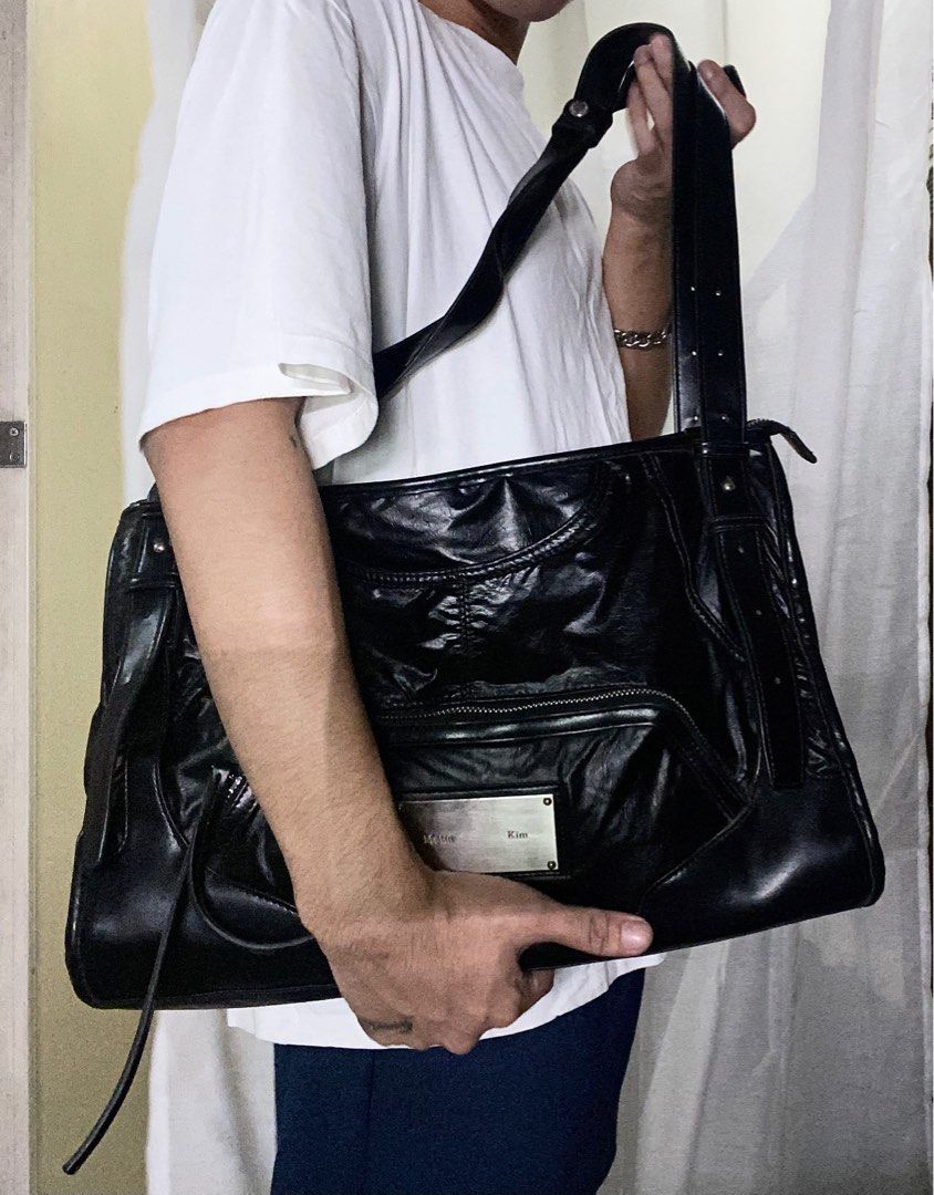 Matin Kim Black Leather Shoulder Bag (Category: Shoulder Bags) located in Manila. Submitted by reirapture (Listing ID 1461442582, Image 1). Description: - Brand: Matin Kim - Material: Black Leather - Finish: Shiny, slightly crinkled - Features: Multiple zippered pockets, front pouch - Straps: Adjustable with buckle details - Hardware: Silver-tone logo plate - Interior: Spacious, ideal for everyday use NEGOTIABLE PA!!!.