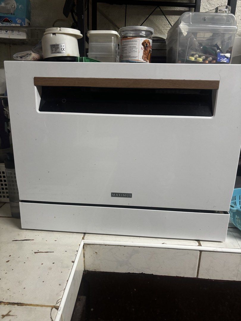 Maximus Countertop Dishwasher (Category: Dishwasher) located in Makati City. Submitted by bbnski (Listing ID 1465928554, Image 1). Description: - Brand: Maximus Countertop Dishwasher - Color: White with a chic wooden accent handle - Ideal for: Small kitchens, apartments, and condo living - Inclusions: racks and cutlery basket ( will include free dishwashing soap) - Condition: Good working condition; interior cavity and door just need a quick wipe
