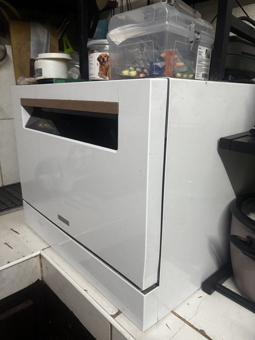 Maximus Countertop Dishwasher (Category: Dishwasher) located in Makati City. Submitted by bbnski (Listing ID 1465928554, Image 2). Description: - Brand: Maximus Countertop Dishwasher - Color: White with a chic wooden accent handle - Ideal for: Small kitchens, apartments, and condo living - Inclusions: racks and cutlery basket ( will include free dishwashing soap) - Condition: Good working condition; interior cavity and door just need a quick wipe