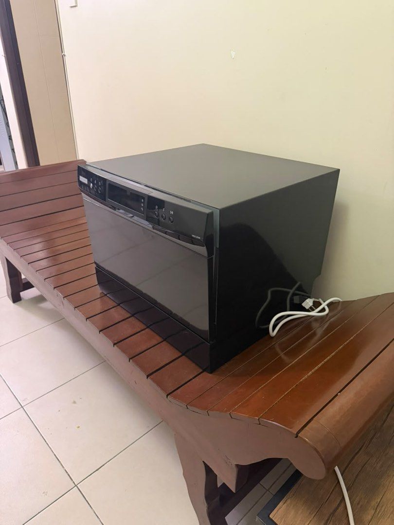Maximus MAX-002B Countertop Dishwasher (Category: Dishwasher) located in Manila. Submitted by jonkakkee (Listing ID 1465845916, Image 3). Description: - Brand/Model: Maximus MAX-002B Countertop Dishwasher - Color: Sleek Black - Control: Modern digital touch control panel on the front - Design: Compact size with a convenient pull-down door - Interior: Includes bottom rack, cutlery basket, and spray arm assembly - Dispenser: Built-in inside the doo