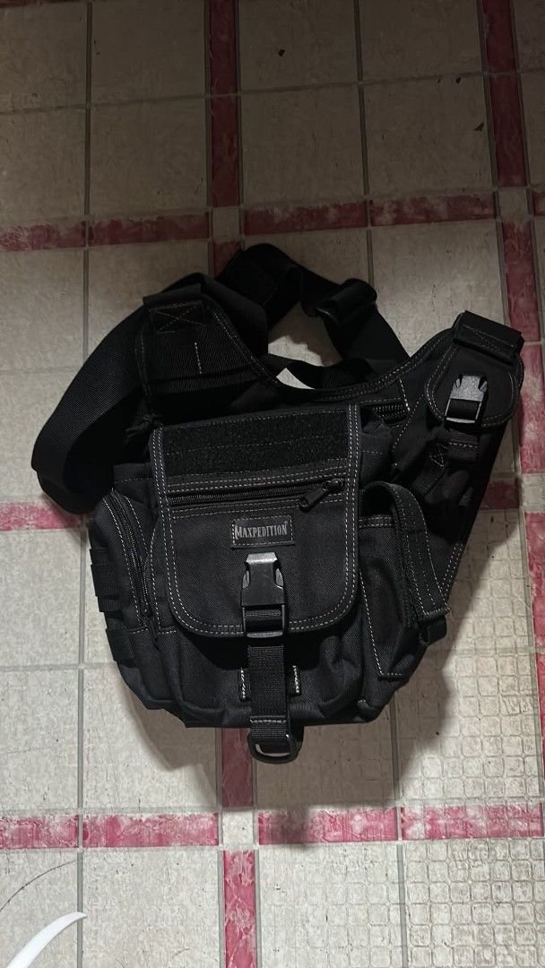 Maxpedition Jumbo Versipack Multi-Compartment Sling Bag (Category: Sling Bags) located in Marikina City. Submitted by lhanz15 (Listing ID 1465811862, Image 1). Description: - Authentic Maxpedition Jumbo Versipack in tactical black - Heavy-duty nylon construction built for rugged use - Multi-compartment design with organization loops - Features a built-in bottle holder for hydration on the go - Equipped with a quick-release strap for easy access -