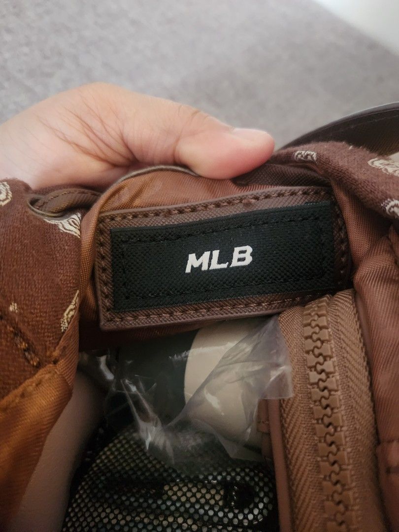 MLB Bucket Bag (Category: Cross-body Bags) located in Binan City. Submitted by prettyfishcakeee (Listing ID 1465762293, Image 3). Description: - Authentic MLB Boston Red Sox bucket bag in brown monogram print - Front pocket with large embroidered team logo - Secure drawstring closure - Adjustable canvas crossbody strap with branded metal hardware - Branded interior fabric label - Compact and stylish, perfect for everyday wear.
