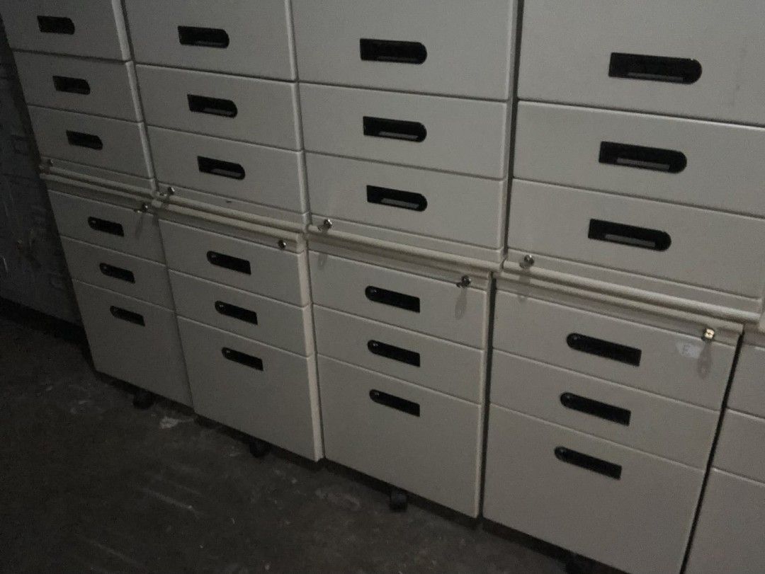 Metal mobile filing cabinet with multiple drawers (Category: Office Furniture & Fixtures) located in Manila. Submitted by cleverocean.10acf9 (Listing ID 1465770618, Image 1). Description: - Color: Off-white - Material: Heavy-duty metal - Features: Multiple drawers for paperwork and supplies, stylish black recessed handles - Security: Built-in lock mechanism on the upper section - Mobility: Smooth-rolling casters underneath for easy repositioning 