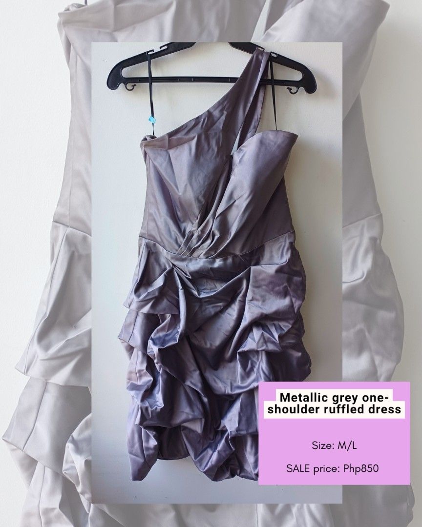 Metallic Grey One-Shoulder Ruffled Dress (Category: Dresses) located in Makati City. Submitted by freegem.c6de30 (Listing ID 1465841928, Image 1). Description: - Color/Finish: Metallic grey with a shiny satin finish - Design: One-shoulder strap, asymmetrical bodice with structured draping - Details: Voluminous ruffles running down the front and sides - Occasion: Ideal as a statement piece for parties, weddings, and formal nights out - Size: Best 