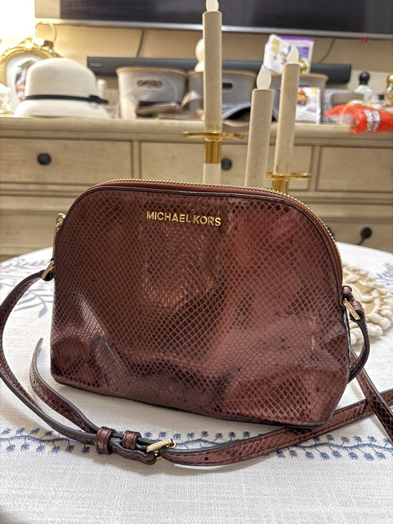 Michael Kors Adele MD Dome Crossbody Merlot (Category: Cross-body Bags) located in Quezon City. Submitted by cndcvrtc (Listing ID 1465945172, Image 1). Description: - Brand: Michael Kors - Model: Adele Medium Dome Crossbody - Color: Merlot (Metallic Embossed Snakeskin Leather) - Hardware: Gold-tone - Closure: Top zip - Strap: Adjustable and removable leather strap - Interior: Fabric lined compartment.