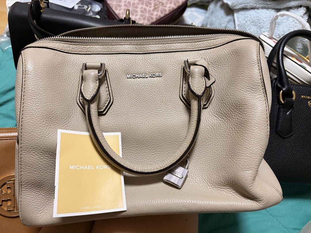 Michael Kors beige leather satchel bag (Category: Luxury Bags & Wallets) located in Cavite. Submitted by pitodyserr47032 (Listing ID 1465897452, Image 1). Description: - Authentic Michael Kors satchel in versatile beige/taupe pebble leather - Sleek silver-tone hardware with a charming mini padlock accent on the front - Secure top-zip closure and comfortable double handles - Structured shape with a clean, premium texture - Includes original care c