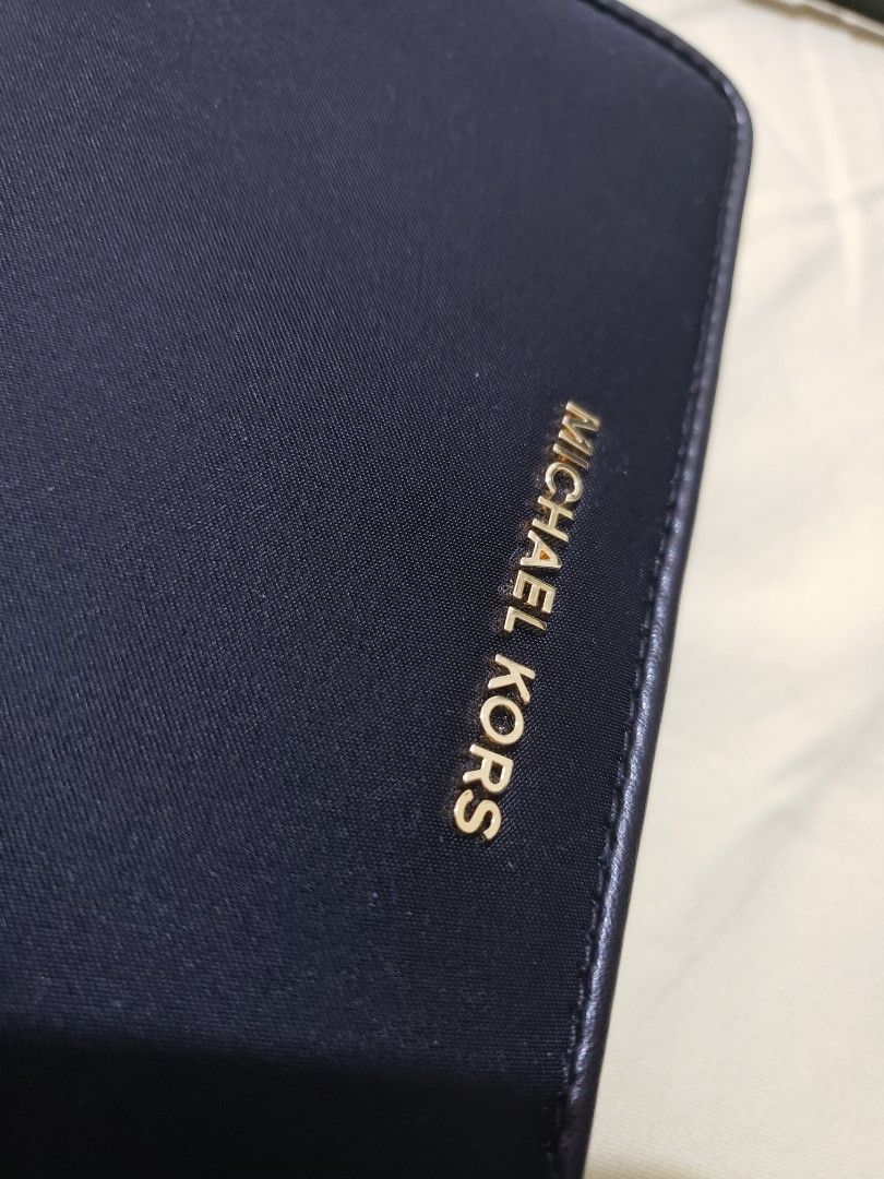 Michael Kors Black Zip Around Wallet With Wristlet Strap (Category: Wallets & Card holders) located in Navotas City. Submitted by miloklo (Listing ID 1465842667, Image 2). Description: Black Michael Kors zip around wallet. Gold tone hardware and matching wristlet strap. Interior holds multiple card slots, slip pockets, and a zippered coin compartment. Protective foam inserts and brand cards still inside. Clean black lining throughout. Zip closure