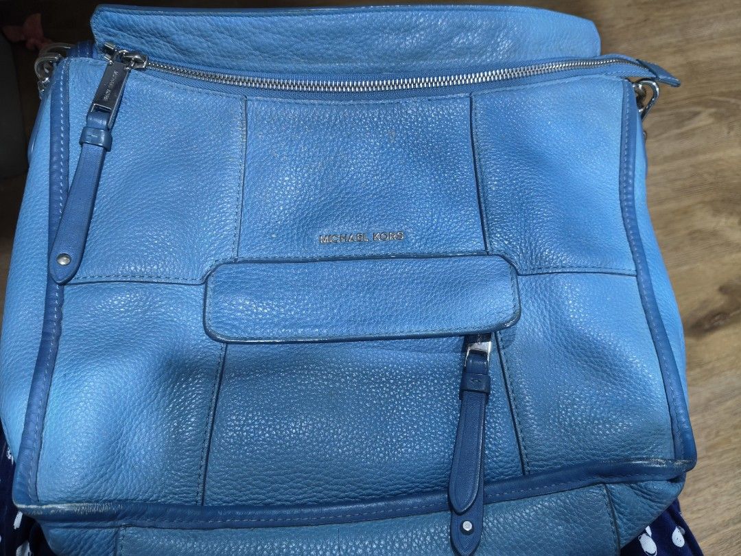Michael Kors Blue Leather Crossbody Bag (Category: Cross-body Bags) located in Tarlac. Submitted by momma02 (Listing ID 1465783633, Image 2). Description: - Brand: Michael Kors - Color: Bright Blue - Material: Genuine pebbled leather - Hardware: Silver-tone with metal logo lettering - Closures: Secure zipper closures - Pockets: Convenient front pocket with pull tab detail - Strap: Includes adjustable and detachable long shoulder strap for versati