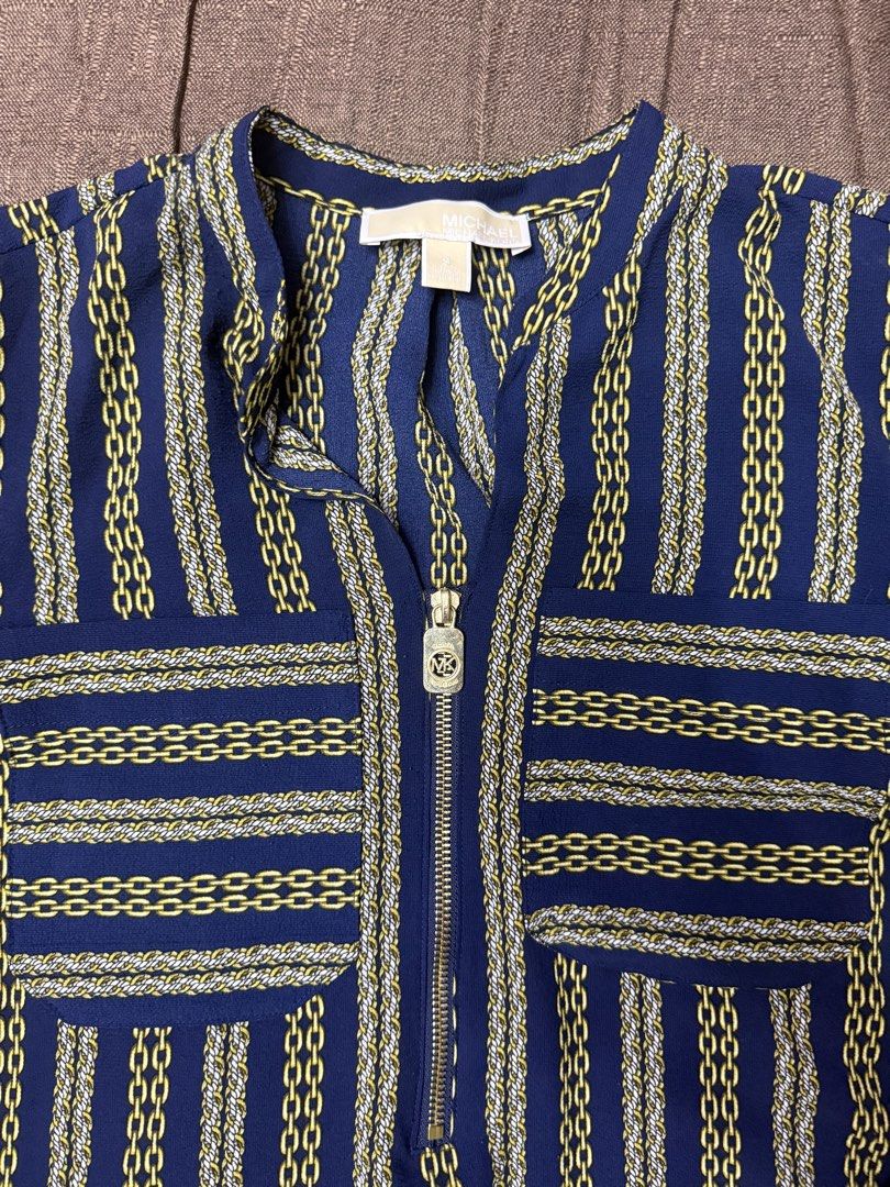 Michael Kors Chain Print Blue Blouse Size S (Category: Blouses) located in Quezon City. Submitted by mt031199 (Listing ID 1465947421, Image 2). Description: - Brand: Michael Kors - Size: Small - Color/Pattern: Deep blue with gold and white chain stripes - Features: Quarter-zip neckline with MK logo zipper pull, two front chest pockets - Fabric: Lightweight and comfortable - Condition: Brand new with tags - Ideal for: Workwear, smart-casual outing