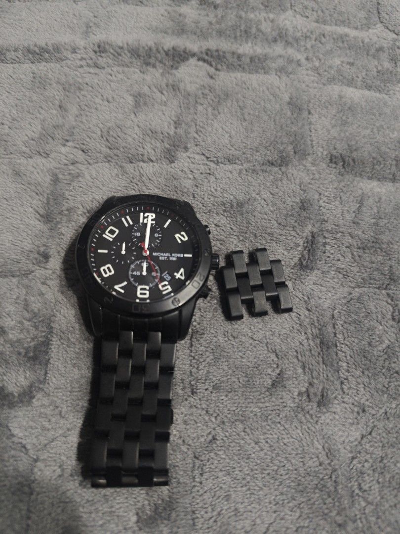 Michael Kors Chronograph Black Watch with Extra Links (Category: Luxury Watches) located in Manila. Submitted by hhebaccnt1 (Listing ID 1465843545, Image 2). Description: - Brand: Michael Kors Men's Watch - Color: Sleek all-black matte finish (case, bezel, and bracelet) - Dial: Dark dial with white numeric markers, 3 sub-dials, and date window - Closure: Secure deployment clasp - Extras: Includes 4 removable links for easy wrist sizing - Mode of 