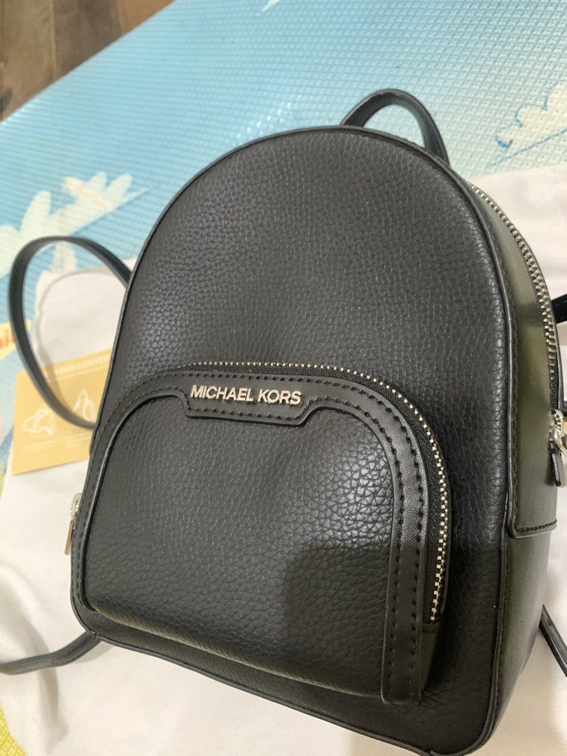 Michael Kors Convertible Backpack Crossbody Bag Black (Category: Backpacks) located in Marikina City. Submitted by sundaysantos (Listing ID 1465773140, Image 3). Description: - Brand: Michael Kors - Material: Premium black pebbled leather - Style: Convertible (switches from backpack to crossbody) - Hardware: Silver-tone with front logo lettering - Storage: Convenient front zip pocket - Inclusions: Care card and instruction manual included - Condi