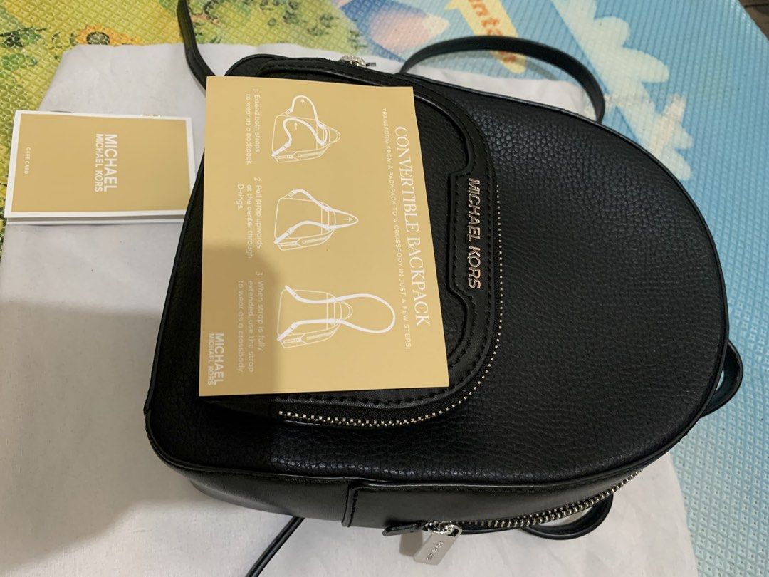 Michael Kors Convertible Backpack Crossbody Bag Black (Category: Backpacks) located in Marikina City. Submitted by sundaysantos (Listing ID 1465773140, Image 2). Description: - Brand: Michael Kors - Material: Premium black pebbled leather - Style: Convertible (switches from backpack to crossbody) - Hardware: Silver-tone with front logo lettering - Storage: Convenient front zip pocket - Inclusions: Care card and instruction manual included - Condi