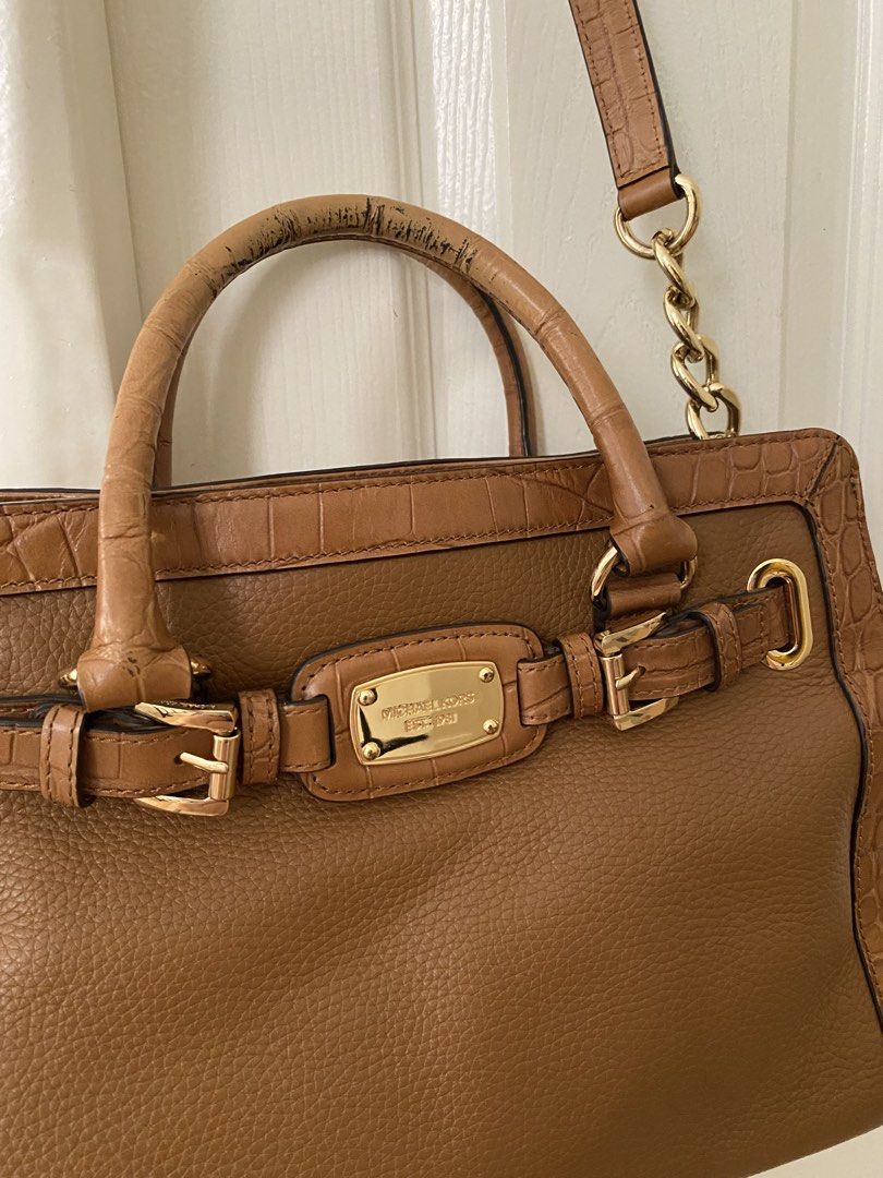 Michael Kors Hamilton Satchel (Category: Shoulder Bags) located in Las Pinas. Submitted by sherylandmargaux (Listing ID 1465846731, Image 3). Description: • Brand: MICHAEL Michael Kors • Model: Hamilton (East-West Satchel/Tote style) • Material: Brown pebbled leather body with croc-embossed trim and dual top handles • Hardware: Gold-tone accents, logo-engraved buckle/belt detail, and chain-link shoulder strap.
