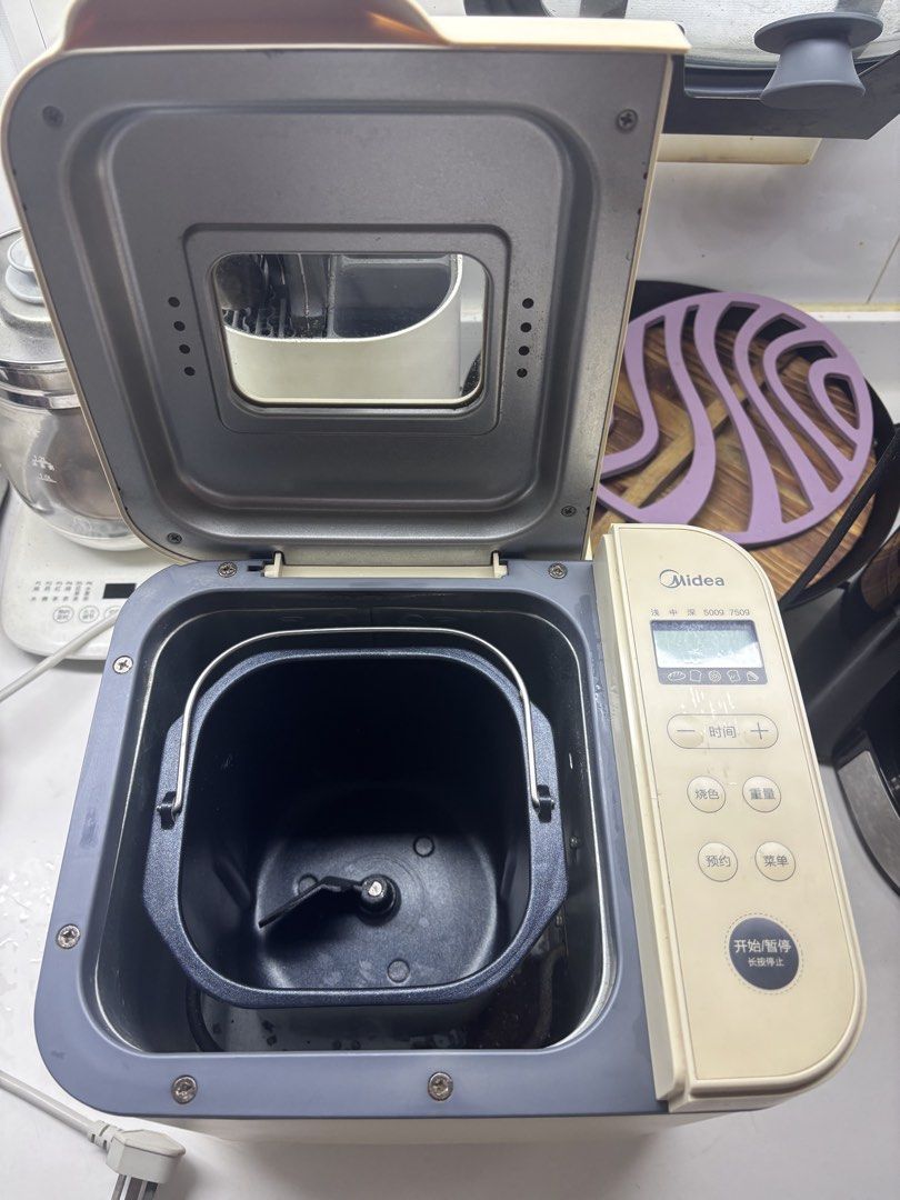 Midea Bread Maker (Category: Breadmakers) located in Singapore. Submitted by martinyang156-98949 (Listing ID 1465896384, Image 2). Description: Bought in 2022. All functional. - Brand: Midea - Capacity: 500g and 750g loaf sizes - Features: Digital control panel with preset menus (standard bread, sweet bread, whole wheat, cake, and jam) - Included: Non-stick inner baking pan with kneading blade and attached power cord - Condition: Clean interior, 