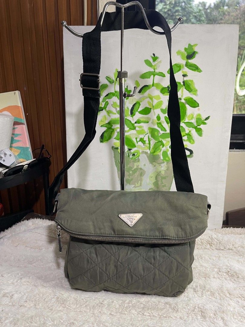 Milbore Green quilted nylon shoulder bag with adjustable strap (Category: Shoulder Bags) located in Naawan. Submitted by twilly.apparel2 (Listing ID 1465846621, Image 2). Description: issue faded, na tanggal napo ang leather Green nylon shoulder bag with quilted bottom pocket and metallic logo plaque. Flap closure with zipper detail and magnetic snap. Interior lined with patterned fabric, includes zippered pocket inside. Adjustable black strap fo