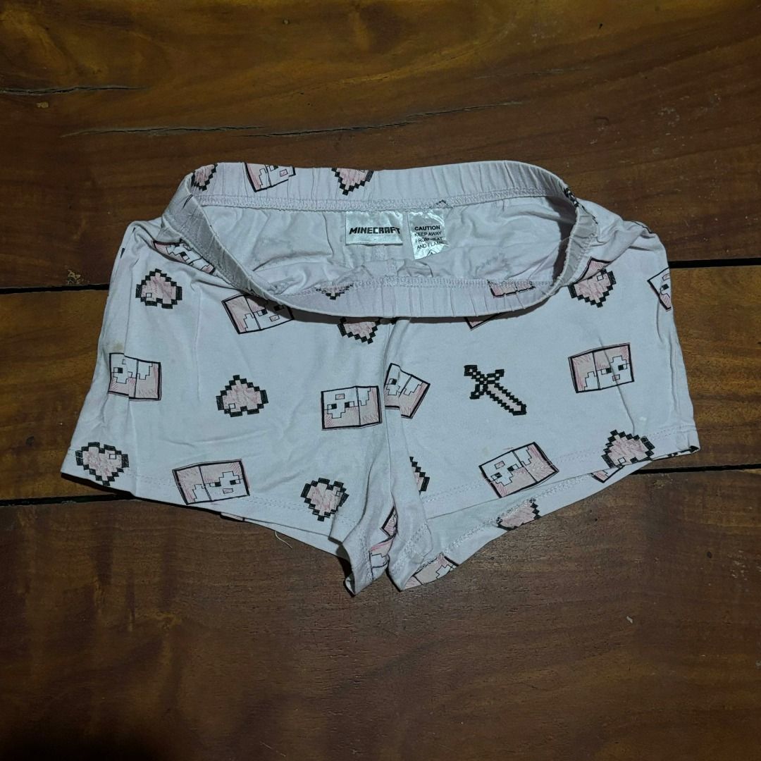 Minecraft Pink Pixel Print Shorts (Category: Shorts) located in Iba. Submitted by fewiclo (Listing ID 1465885282, Image 2). Description: - Color: Light Pink with all-over Minecraft pixel print (hearts, swords, characters) - Comfort: Stretchy elastic waistband for easy lounging or sleeping - Branding: Features official Minecraft inside tag - Condition: Brand new / Great quality - Perfect for: Gaming nights, sleepovers, and daily relaxation.