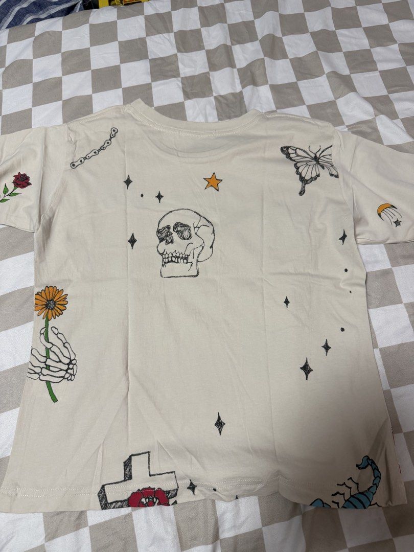 Mingyu Daydreamer Shirt (Category: K-Wave Merchandise) located in Quezon City. Submitted by sbcarrot (Listing ID 1465777104, Image 2). Description: - Brand: Daydreamer - Color: Beige - Design: All-over tattoo-style sketches (skull, spiderweb, 8-ball, cross) - Celebrity Style: Worn by Mingyu from Seventeen - Fit/Material: Short sleeves, crew neck, soft cotton fabric - Style: Streetwear, great for fans and collectors.