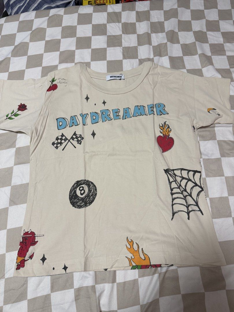 Mingyu Daydreamer Shirt (Category: K-Wave Merchandise) located in Quezon City. Submitted by sbcarrot (Listing ID 1465777104, Image 1). Description: - Brand: Daydreamer - Color: Beige - Design: All-over tattoo-style sketches (skull, spiderweb, 8-ball, cross) - Celebrity Style: Worn by Mingyu from Seventeen - Fit/Material: Short sleeves, crew neck, soft cotton fabric - Style: Streetwear, great for fans and collectors.