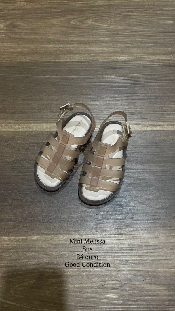Mini Melissa Sandals 8 US 24 Euro (Category: Babies & Kids Fashion) located in Bacolod City. Submitted by jmcercado (Listing ID 1465926515, Image 1). Description: - Brand: Mini Melissa - Style: Classic cage jelly sandals with buckle ankle strap - Color: Neutral tone (easy to match with any outfit) - Size: 8 US / 24 Euro - Condition: Good, worn just a few times with minimal wear on soles - Material: Ultra-soft, comfortable jelly for little feet - 
