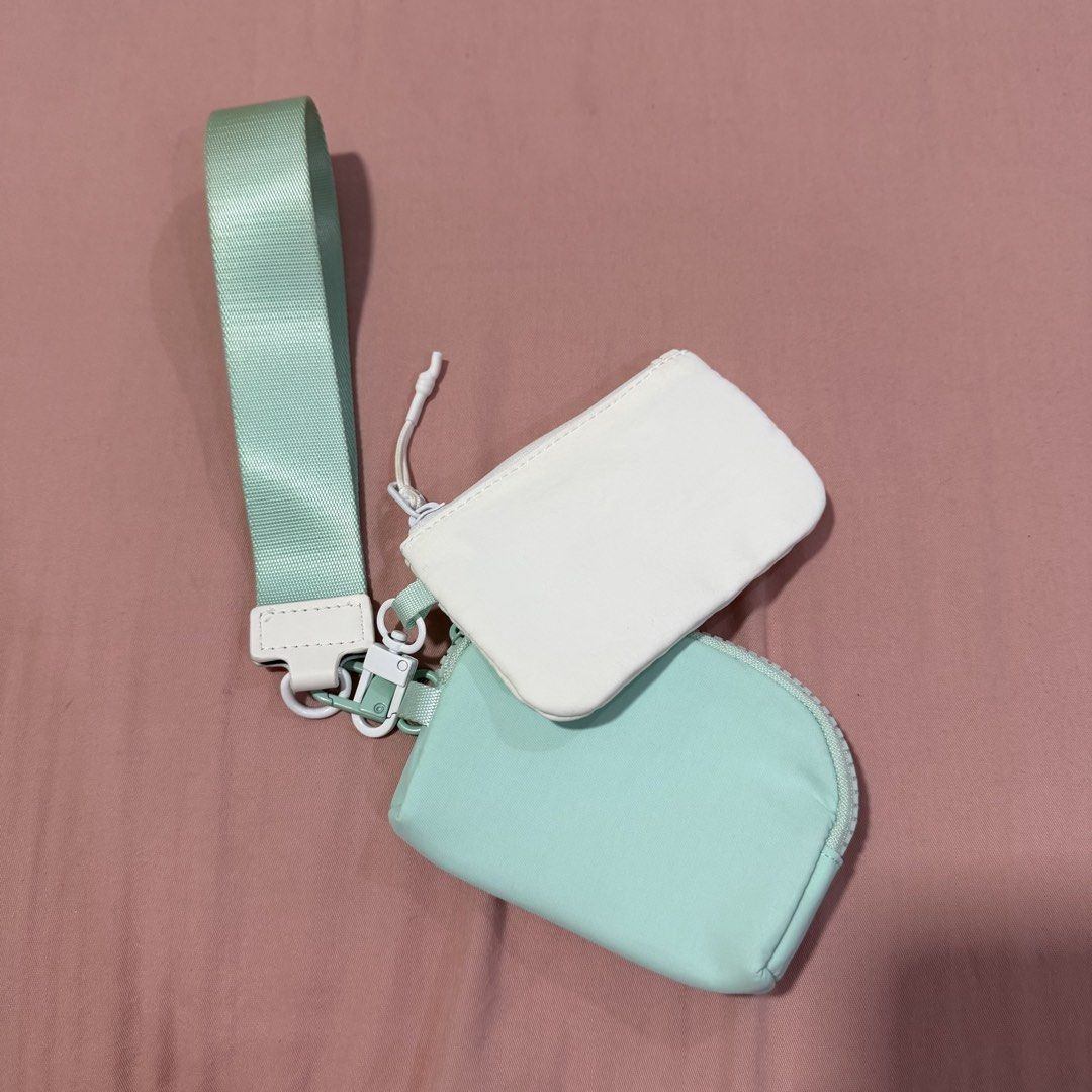Mint green and white multi pouch set with strap (Category: Purses & Pouches) located in Caloocan City. Submitted by preloveditemsbyyana (Listing ID 1465934786, Image 1). Description: - Mint green and white modular pouch set - Includes two separate zipped pouches: a white rectangular top pouch and a mint curved bottom pouch - Attached to a stylish and comfortable wide wrist strap - Features sleek white hardware accents and clips - Practical modula