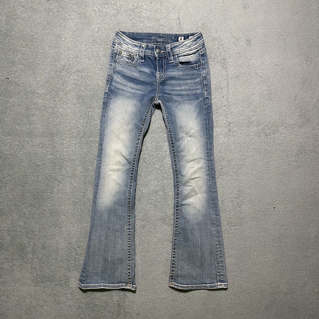 Miss Me Bootcut Jeans Size 8 (Category: Jeans) located in Villaverde. Submitted by bakatzy_secondhand_garments (Listing ID 1465886458, Image 2). Description: - Brand/Model: Miss Me Girls Bootcut Jeans (Style: K3080BG, Color: L186) - Size: 8 (Tag at waist) - Wash: Medium wash with stylish light fading on thighs and knees - Details: Eye-catching rhinestone wing embellished button-flap back pockets and contrast white stitching - Material: 92% cotton