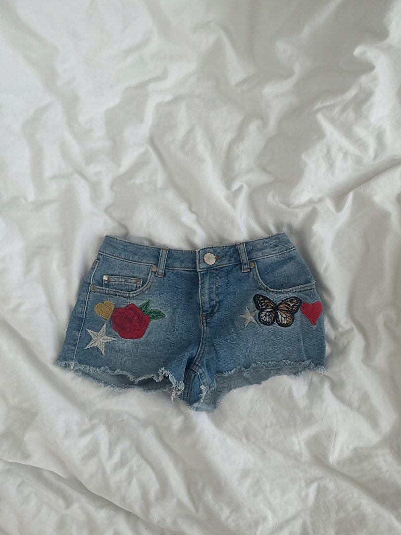 Patchwork Low Rise Denim Mini Shorts (Category: Shorts) located in Taguig. Submitted by babyspice888 (Listing ID 1465780342, Image 1). Description: Miss Selfridge Petite Denim Patchwork Shorts — Discontinued!!! Super cute Y2K-style denim shorts with embroidered rose, butterfly, heart & star patches + distressed/frayed hem. Brand: Miss Selfridge Petites Condition: Barely worn, good condition, no flaws Original Selling price = £30–£40 (₱2400-₱3200)