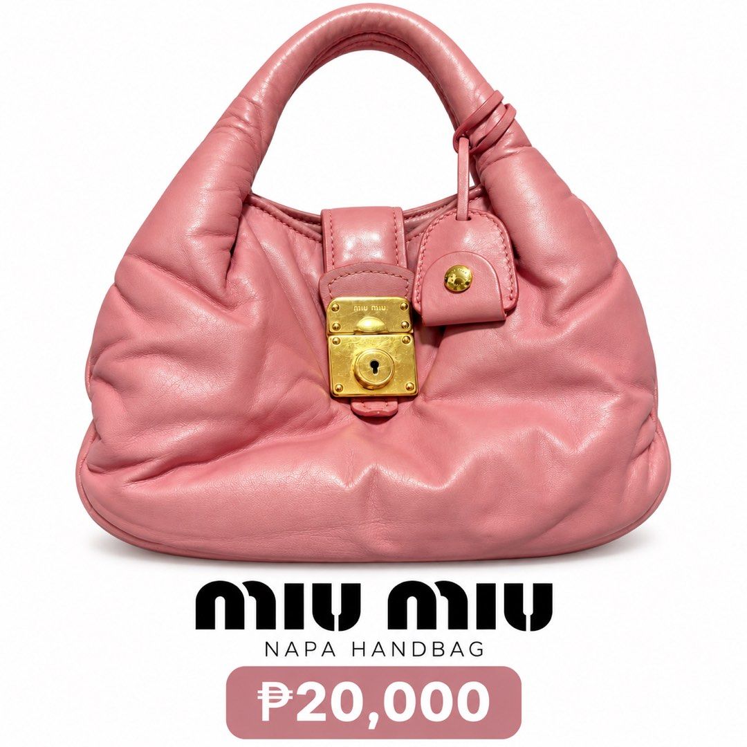 Miu Miu Napa Handbag Pink (Category: Luxury Bags & Wallets) located in Manila. Submitted by doreal (Listing ID 1465945662, Image 1). Description: - Authentic pink Miu Miu napa handbag in soft, premium leather - Elegant gold-tone hardware and signature metal lock closure - Convenient single top handle design - Structured bottom with a chic curved shape - Compact and lightweight, perfect for daily essentials - Impeccable stitching and craftsmanship