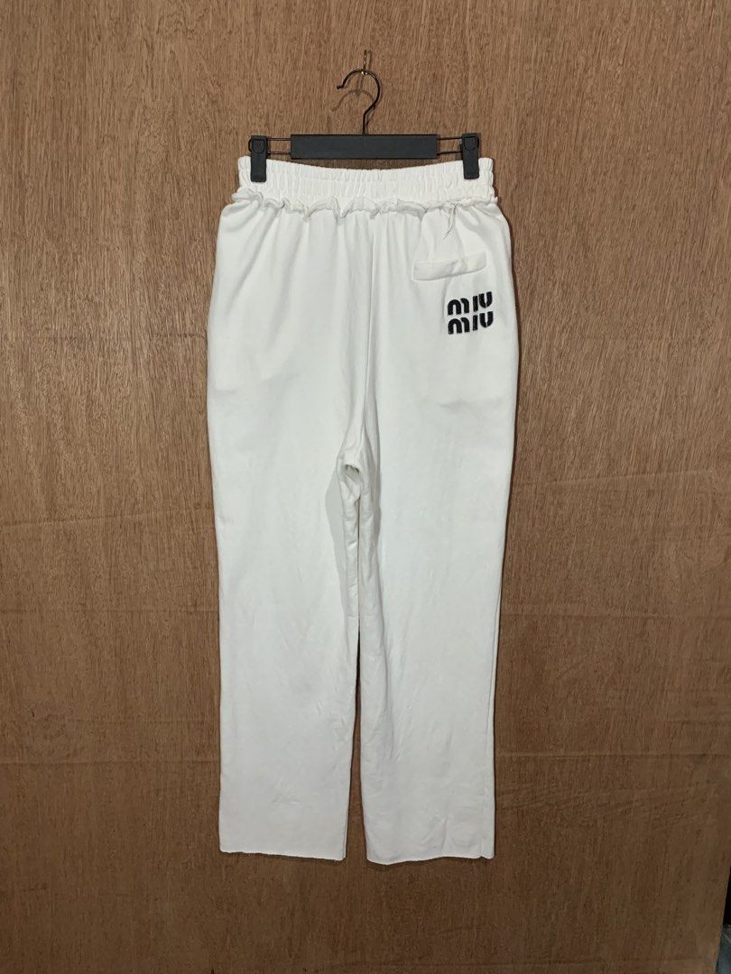 Miu Miu White Sweatpants Joggers (Category: Other Bottoms) located in Tacurong. Submitted by ljsthrift (Listing ID 1465764270, Image 1). Description: - Brand: Miu Miu - Color: Clean White - Fit: Relaxed fit with soft cotton terry interior for ultimate comfort - Details: Elastic waistband with ruffled trim, single back pocket with black printed logo - Origin: Made in Italy - Condition: Gently worn.