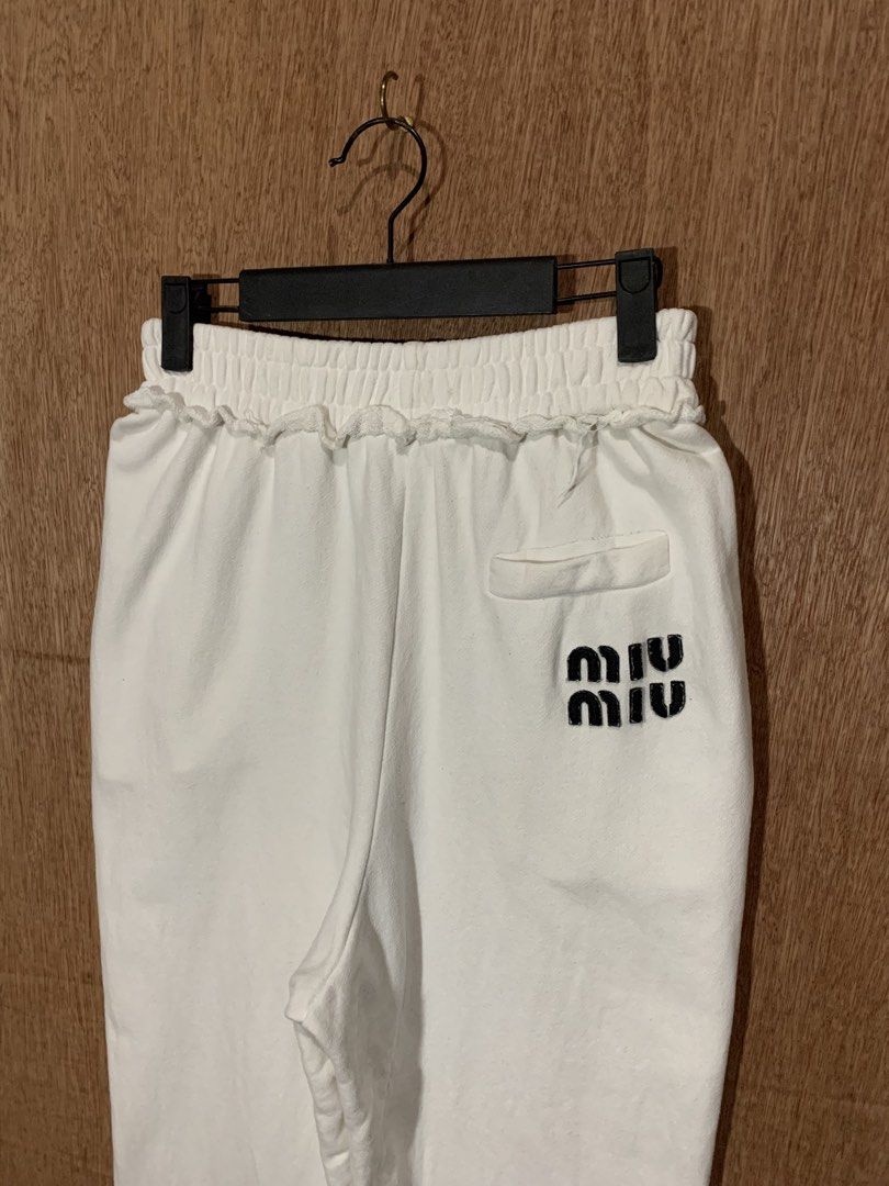 Miu Miu White Sweatpants Joggers (Category: Other Bottoms) located in Tacurong. Submitted by ljsthrift (Listing ID 1465764270, Image 3). Description: - Brand: Miu Miu - Color: Clean White - Fit: Relaxed fit with soft cotton terry interior for ultimate comfort - Details: Elastic waistband with ruffled trim, single back pocket with black printed logo - Origin: Made in Italy - Condition: Gently worn.