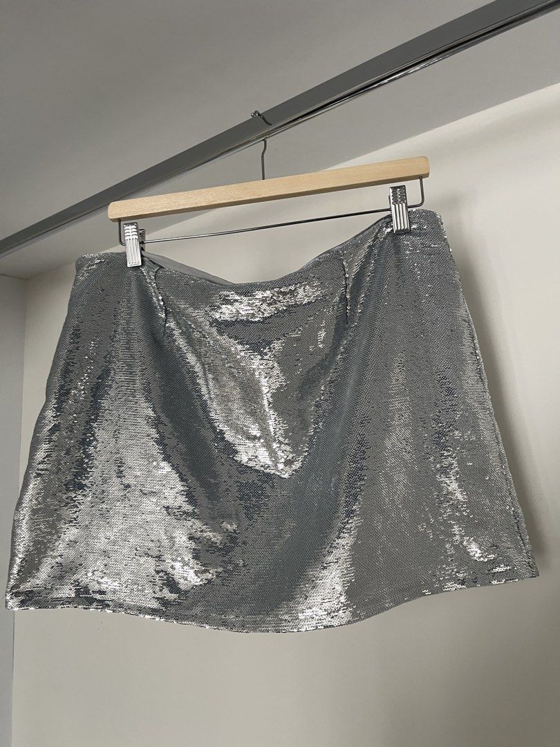 Mango Silver Sequin Mini Skirt (Category: Skirts) located in Quezon City. Submitted by cooperminie (Listing ID 1465816099, Image 2). Description: - Size: XL (Waist: approx. 18.5" across, Length: approx. 18", fabric slightly stretchy) - Color/Design: All-over shiny silver sequins with a comfortable grey lining and waistband - Closure: Easy-to-use back zipper - Perfect for: Parties, night outs, concerts, and events - Condition: Great statement piec