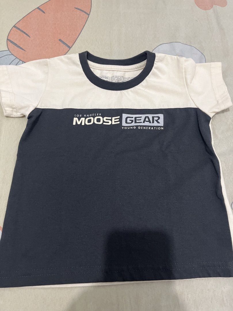 Moose Gear Two-Tone T-Shirt (Category: Babies & Kids Fashion) located in Manila. Submitted by luckywind_6a22e1 (Listing ID 1465905456, Image 1). Description: - Brand: Moose Gear - Size: Medium - Design: Color block (Off-white top, dark grey bottom) - Details: Crew neck collar and 'Los Angeles Moose Gear Young Generation' chest print - Fit: Standard fit for everyday wear - Material: Soft and comfortable cotton.