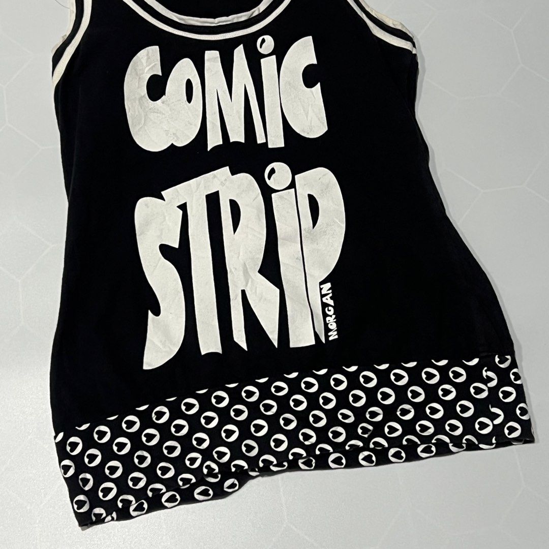 Morgan De Toi Comic Strip Tank Top (Category: Sleeveless) located in Caloocan City. Submitted by lostarchive_55 (Listing ID 1465915736, Image 2). Description: - Brand: Morgan De Toi - Style: Y2K vintage black tank top - Details: White contrast ribbing, scoop neckline, and sleeveless cut - Graphic: Bold 'COMIC STRIP' print on the front - Hem: Cute black and white heart pattern detail - Pairing: Perfect to style with cargo pants, low-rise jeans, or