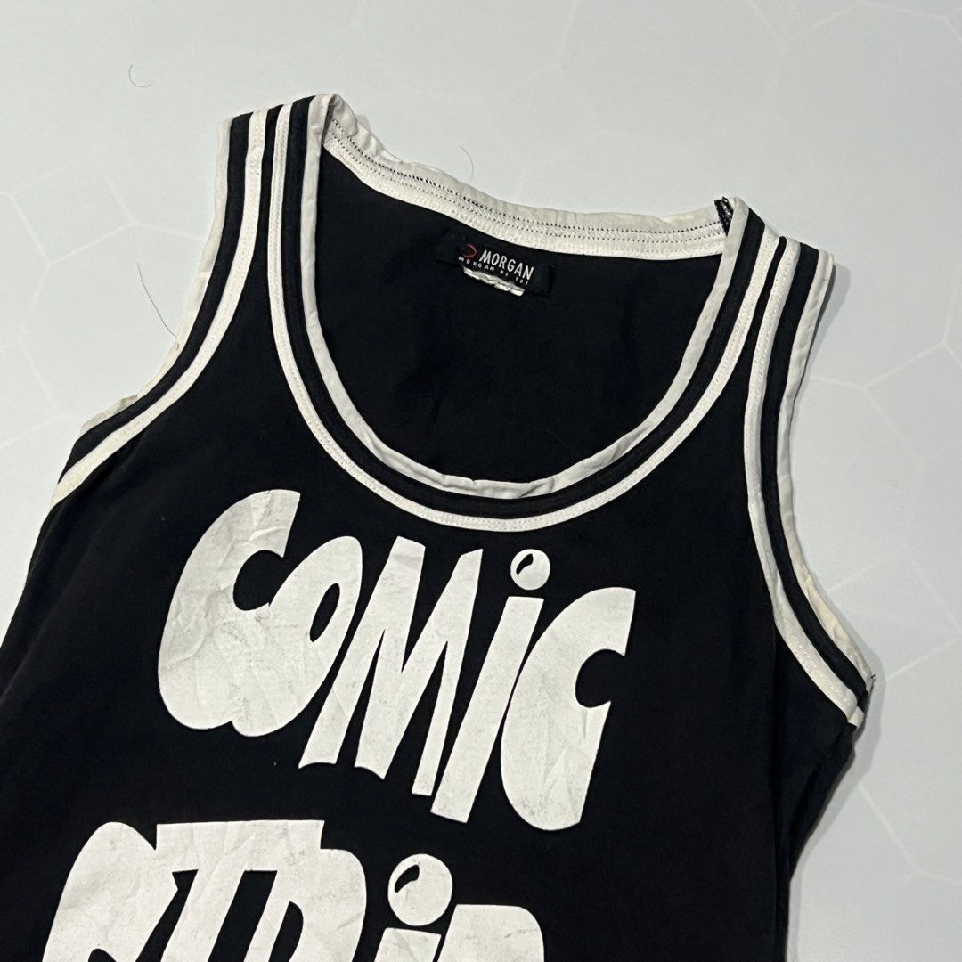 Morgan De Toi Comic Strip Tank Top (Category: Sleeveless) located in Caloocan City. Submitted by lostarchive_55 (Listing ID 1465915736, Image 3). Description: - Brand: Morgan De Toi - Style: Y2K vintage black tank top - Details: White contrast ribbing, scoop neckline, and sleeveless cut - Graphic: Bold 'COMIC STRIP' print on the front - Hem: Cute black and white heart pattern detail - Pairing: Perfect to style with cargo pants, low-rise jeans, or
