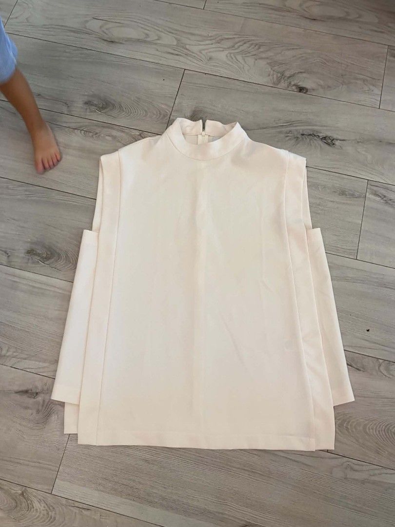Mosaic Cream top (Category: Sleeveless) located in Makati City. Submitted by larasdowry (Listing ID 1465946772, Image 1). Description: Features a high neckline, back zip, and stylish layered side panels. Perfect neutral piece for the office or casual outings. Hand wash cold. fits Large to XL..