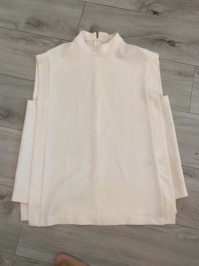 Mosaic Cream top (Category: Sleeveless) located in Makati City. Submitted by larasdowry (Listing ID 1465946772, Image 2). Description: Features a high neckline, back zip, and stylish layered side panels. Perfect neutral piece for the office or casual outings. Hand wash cold. fits Large to XL..
