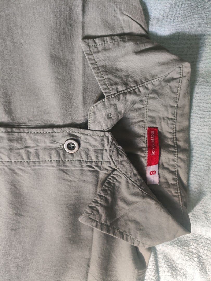 Mossimo Kids Button-Up Shirt Size 8 Beige (Category: Babies & Kids Fashion) located in Manila. Submitted by rarelion_c637f7 (Listing ID 1465853121, Image 2). Description: Mossmo kids button-up shirt in beige. Short sleeves, standard collar, front button closure. Left chest pocket features embroidered text detailing. Small red brand tag on the lower left side seam. Clean look overall, great for everyday wear or casual outings..