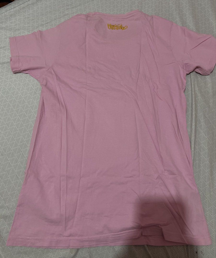 Mossimo Pink T-Shirt Size M (Category: Shirts) located in Manila. Submitted by kaceylgt (Listing ID 1465924506, Image 2). Description: - Brand: Mossimo - Color: Pink with yellow and mustard yellow accents - Size: M - Design: Yellow embroidered chest branding - Details: Layered mustard yellow inner collar with striped trim, plus a small fabric patch near the bottom hem - Condition: Excellent.