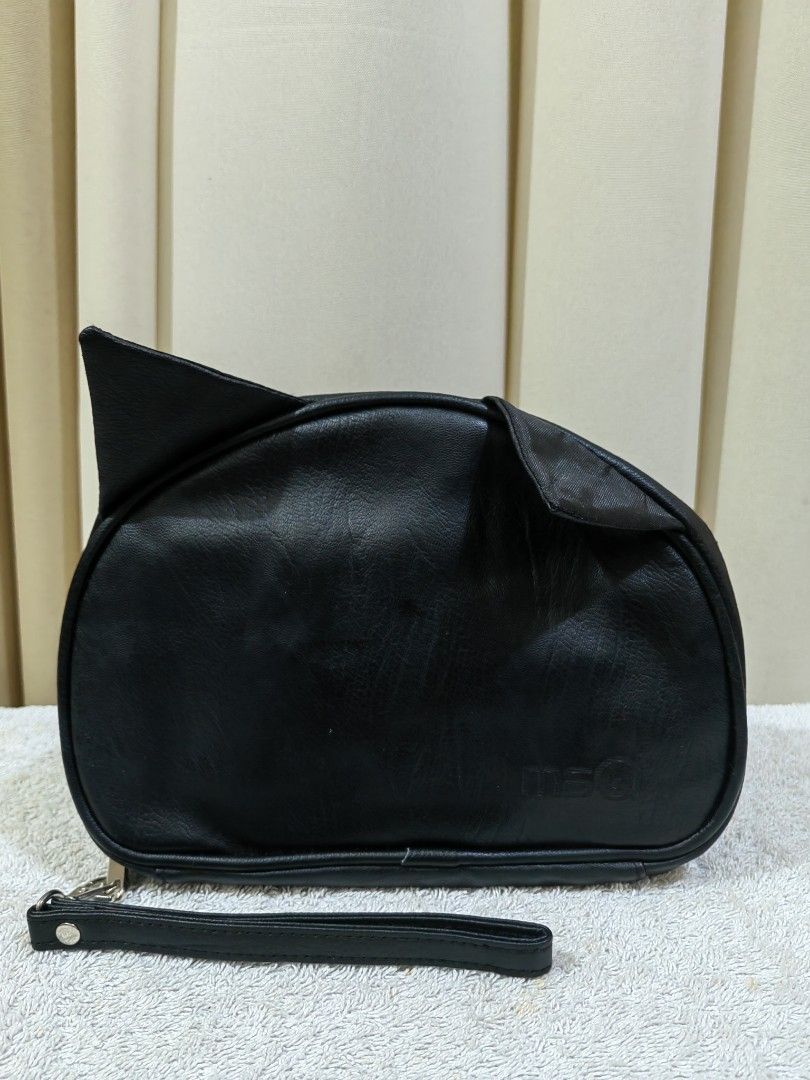 MSQ Black Cat Ear Pouch organizer (Category: Accessory Holder, Box & Organizers) located in Makati City. Submitted by prelovedtreatedwithlove (Listing ID 1465783384, Image 1). Description: - Adorable cat-shaped design in black faux leather with cute ears - MSQ brand - Includes a convenient matching wrist strap on the side - Interior is fully lined with black fabric - Equipped with mesh zipper pockets and elastic loops to securely hold brushes or 
