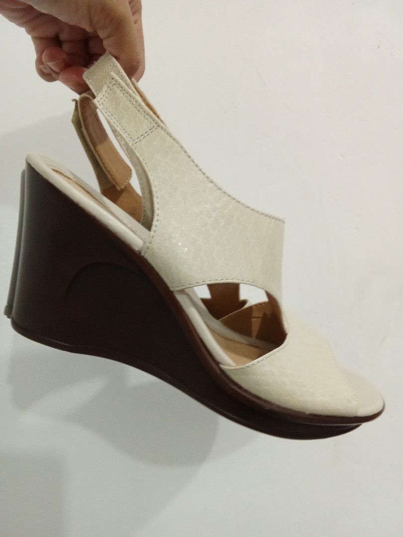 Naturalizer Wedge Sandals Off-White (Category: Flats & Sandals) located in Quezon City. Submitted by jane019 (Listing ID 1465902749, Image 2). Description: - Brand: Naturalizer - Style: Slingback wedges with open toe and wide cutout straps - Color: Off-white textured upper with brown stacked heels - Closure: Adjustable hook and loop back strap for a secure fit - Comfort: Cushioned insoles for all-day wear - Sole: Rubber grip soles with gently wor