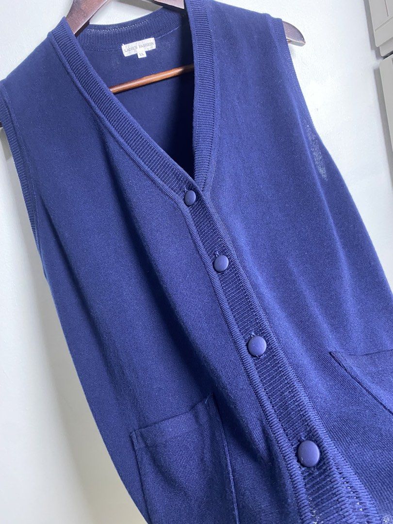 Navy blue button vest (Category: Others Tops) located in Makati City. Submitted by indaysukaycloset (Listing ID 1465842786, Image 2). Description: NAVY BLUE BUTTON VEST Brand: LADIE'S FASHION (Japan Brand) Size: LL on tag - Fits L-XL Color: Navy Blue Details: - W-20.5 L-24 (laid flat, in inches) - V-neck sleeveless button-down vest - Front 5-button closure (fabric-covered buttons) - 2 front patch pockets - Side slits on hem - Fine knit, soft and 
