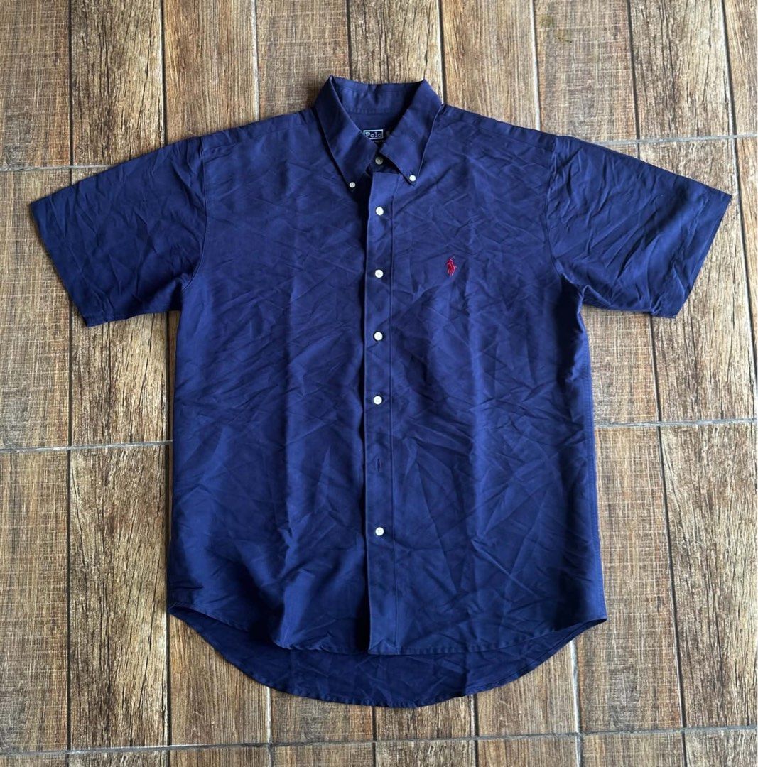 NAVY BLUE RALPH LAUREN BUTTON DOWN (Category: Tshirts & Polo Shirts ) located in Manila. Submitted by urban.vintage (Listing ID 1465792147, Image 1). Description: ISSUE: NONE (NEED WASH) MOP :GCASH (NO COD) SHIP VIA: LALAMOVE & J&T LOCATION: PASIG CITY LENGTH: 29 WIDTH :23 .