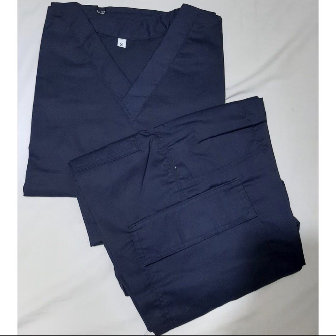Navy Blue Scrub Suit with Cargo Pants Size S (Category: Sets or Coordinates) located in Cavite. Submitted by zhidneygrace (Listing ID 1465901399, Image 1). Description: - Color: Navy blue - Size: Medium (tag attached) - Condition: Unworn, neatly folded - Top: V-neck with short sleeves - Pants: Cargo style with side utility pockets - Perfect for healthcare professionals looking for comfort and functionality Rfs: doesnt fit me.
