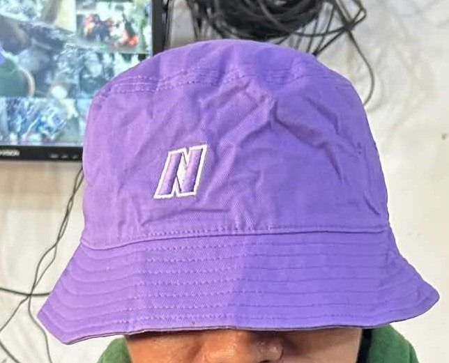 Nerdy Purple Bucket Hat (Category: Caps & Hats) located in General Santos City (Dadiangas). Submitted by moana_thrifts (Listing ID 1465811508, Image 1). Description: - Brand: Nerdy - Color: Bright purple - Material: Sturdy cotton twill - Design: Embroidered signature 'N' logo on front, full brand name on back in white stitching - Fit: Classic unstructured fit - Style: Casual everyday streetwear.