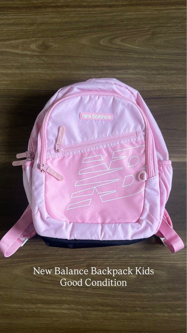 New Balance Kids Pink Backpack (Category: Backpacks) located in Bacolod City. Submitted by jmcercado (Listing ID 1465925625, Image 1). Description: - Brand: New Balance - Color: Bright pink with white logo and black reinforced bottom - Storage: Roomy main compartment with secure zipper closure - Quick Access: Small zippered front pocket for small items - Comfort: Adjustable pink shoulder straps - Condition: Clean fabric inside and out, smoke-free