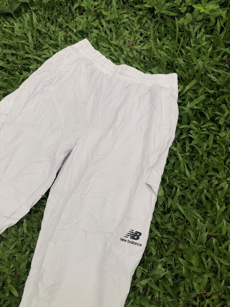 New Balance White Cargo Track Pants Size M (Category: Joggers) located in Kabasalan. Submitted by hamugaway (Listing ID 1465826347, Image 2). Description: White nylon track pants from New Balance. Elastic waistband with drawstring. Cargo pockets on both legs, small black logo hit near the left knee. Cuffed ankles. Regular fit, lightweight material. Size M tag on the inner label. Great everyday streetwear piece..
