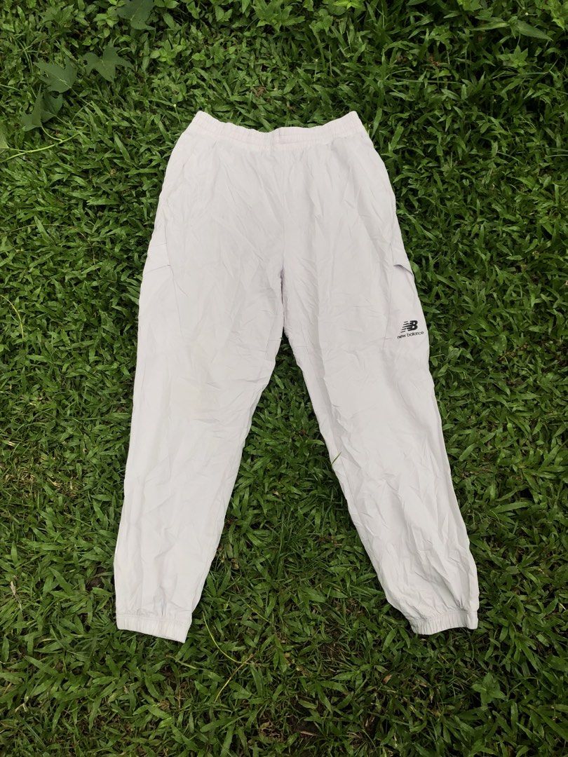 New Balance White Cargo Track Pants Size M (Category: Joggers) located in Kabasalan. Submitted by hamugaway (Listing ID 1465826347, Image 1). Description: White nylon track pants from New Balance. Elastic waistband with drawstring. Cargo pockets on both legs, small black logo hit near the left knee. Cuffed ankles. Regular fit, lightweight material. Size M tag on the inner label. Great everyday streetwear piece..