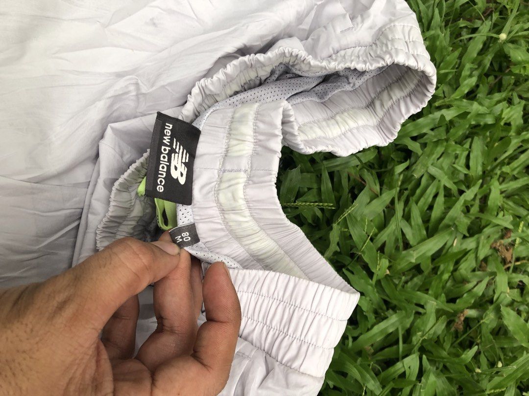 New Balance White Cargo Track Pants Size M (Category: Joggers) located in Kabasalan. Submitted by hamugaway (Listing ID 1465826347, Image 3). Description: White nylon track pants from New Balance. Elastic waistband with drawstring. Cargo pockets on both legs, small black logo hit near the left knee. Cuffed ankles. Regular fit, lightweight material. Size M tag on the inner label. Great everyday streetwear piece..