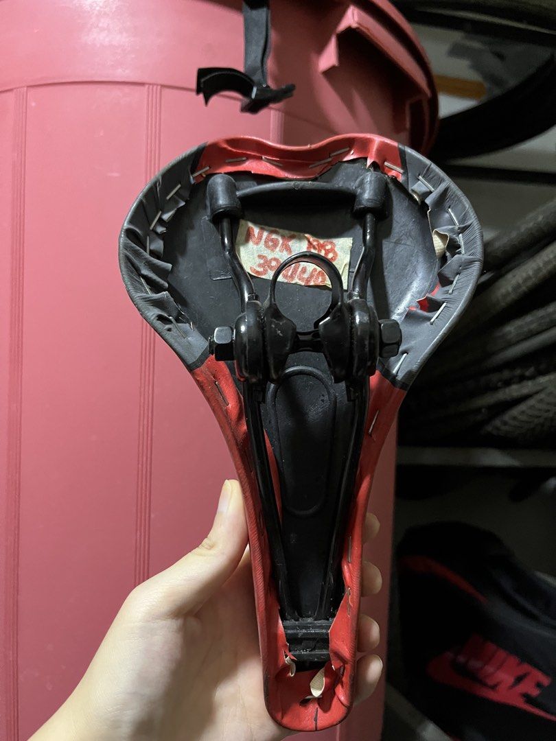 New Century Bicycle Saddle Red Black (Category: Bicycles) located in Santa Rosa. Submitted by weltfish (Listing ID 1465926766, Image 2). Description: Please just message for any questions :) - Color: Red and black - Comfort: Cushioned surface with textured grip patterns and ventilation cutout - Compatibility: Fits standard seatposts - Hardware: Mounting clamp attached underneath with dual rails - Condition: Bottom stapled finish with some wear on