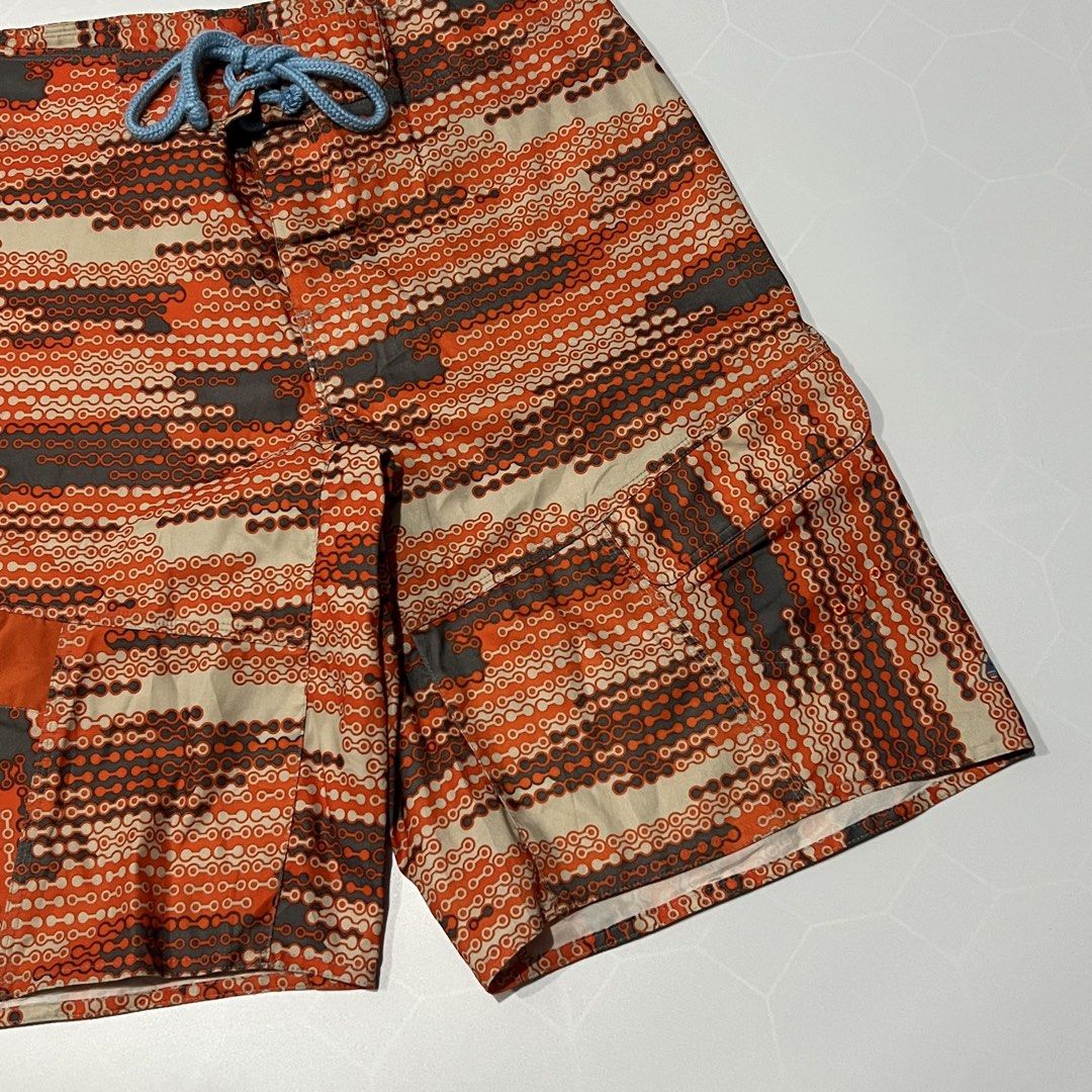 Nike ACG Orange Chainlink Board Shorts (Category: Swim Trunks & Board Shorts) located in Caloocan City. Submitted by lostarchive_55 (Listing ID 1465917433, Image 2). Description: - Brand: Nike ACG - Style: Men's board shorts with an orange and grey chainlink pattern - Size: 34 - Material: 92% polyester, 8% polyurethane (Made in India) - Features: Light blue waist drawstring and a functional cargo pocket on the right leg - Condition: Clean inside 